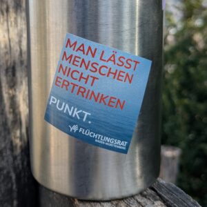 Sticker mit Aufschrift 'Man lässt Menschen nicht ertrinken' mit Meer